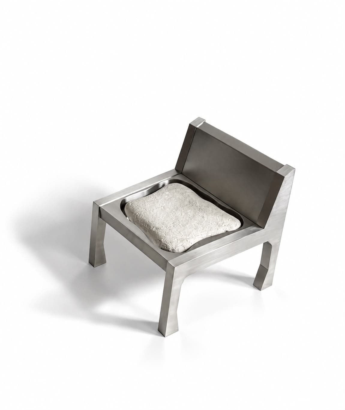 A small steel chair with tapered legs and an angled back, its seat holding a rough pale stone cut to sit like a cushion