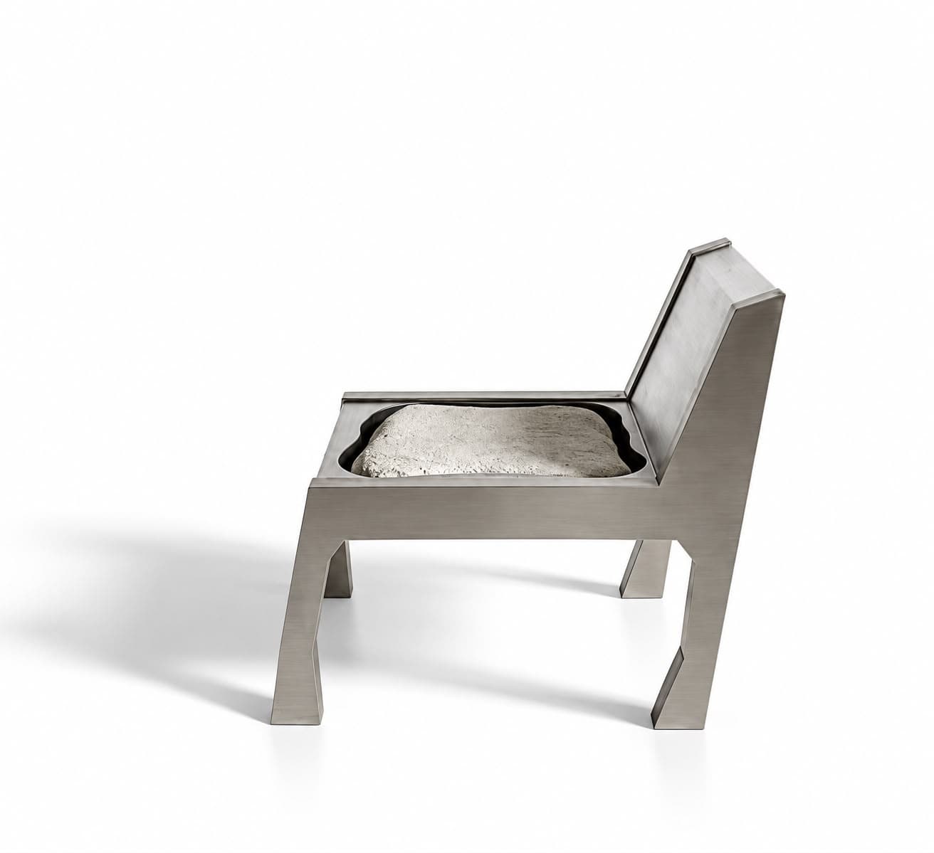 The same chair in profile, the stone seat standing proud of its frame and the back raked sharply away